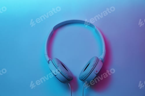 Preview: Stylish modern headphones with earmuffs on color background, top view
