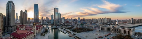 Preview: Aerial shot of an urban skyline with landmarks along the Haihe River in Tianjin, China at sunset