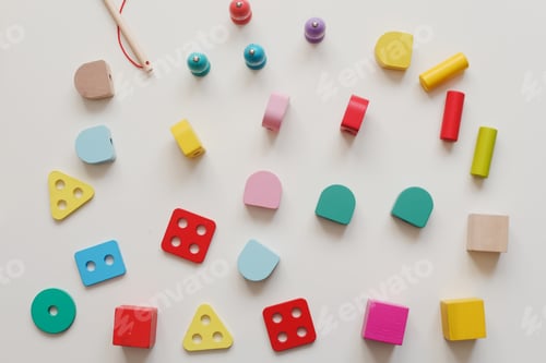 Preview: Top view colorful eco-friendly non-plastic wooden toys on white. Early learning and development