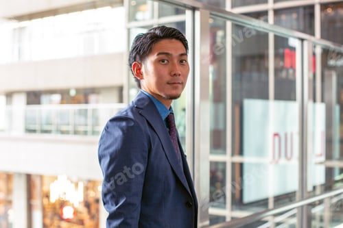 Preview: A young businessman in a suit downtown