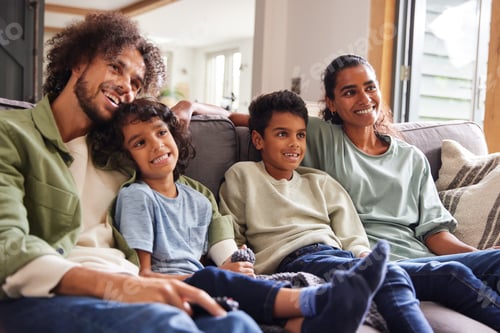 Preview: Family watching TV at home on sofa