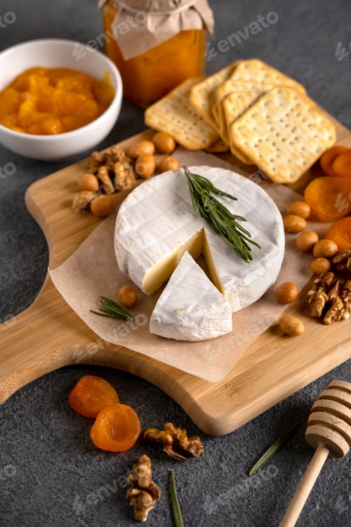 Preview: Brie cheese with nuts, pear slices and dried apricots. Camembert cheese.