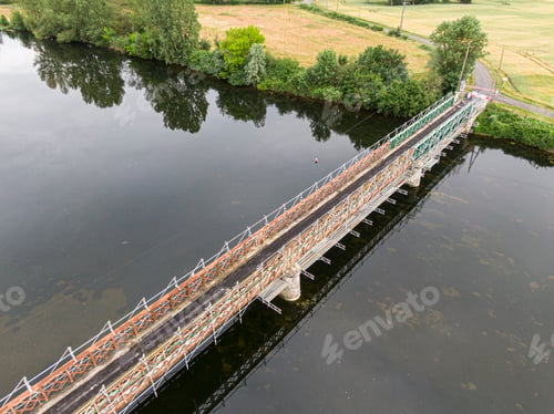 Preview: Scaffolding used for maintenance or restoration work on a small bridge over a large river the Cher
