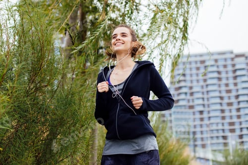 Preview: Young woman running in urban enviroment