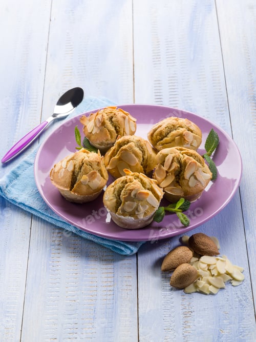 Almond Muffins Displayed on a Purple Plate