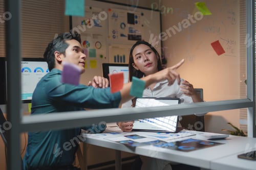Preview: Business professionals collaborating night analyzing marketing data