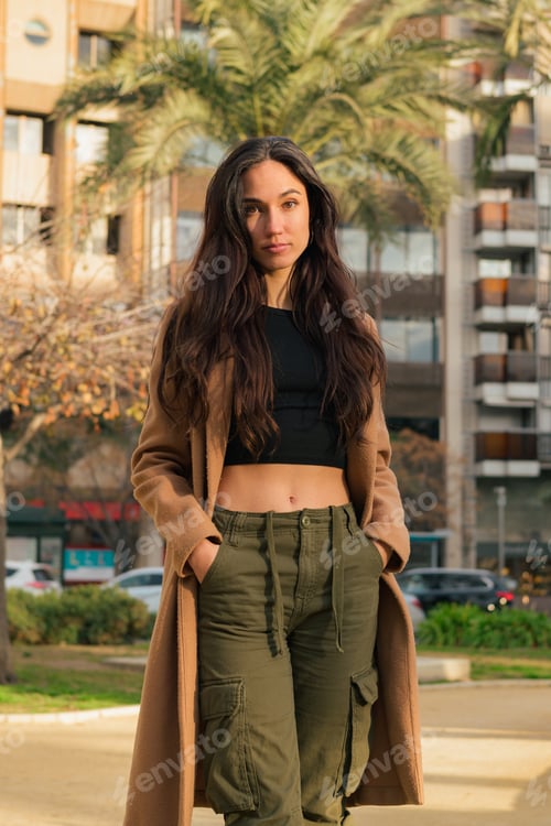 Preview: Portrait of a beauty serious young woman on the street looking at camera