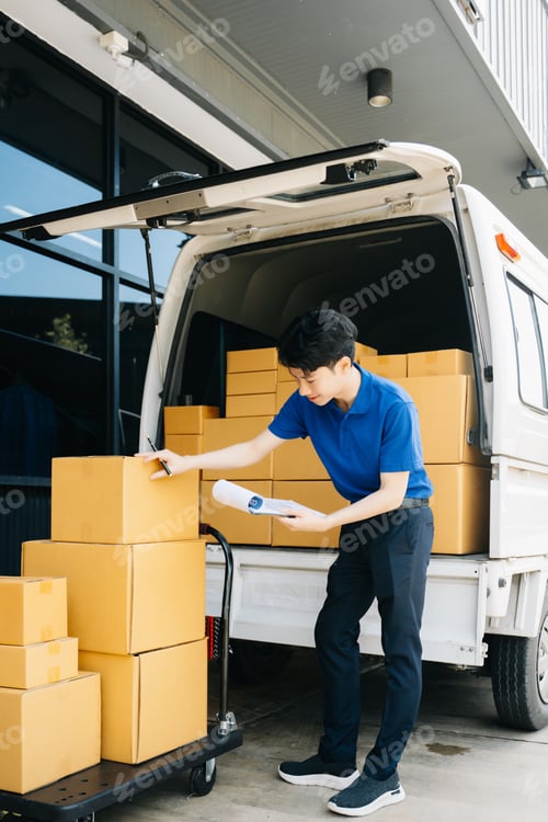 Preview: Asian courier delivery man searching the address on digital tablet. near van outside the warehouse.