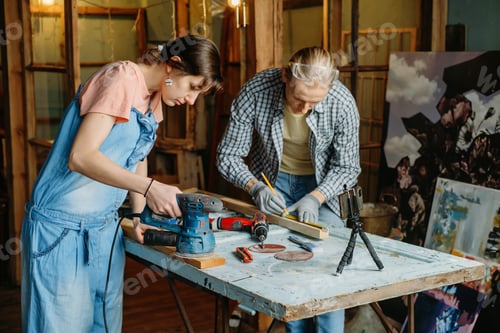 Preview: Man and woman doing refurbishment of furniture