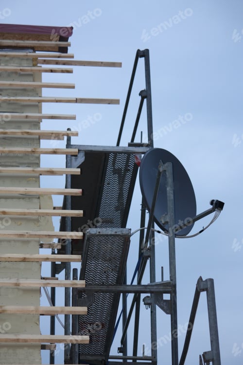 Preview: Vertical shot of a building room with a satellite dish