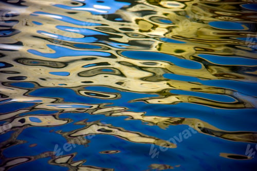 Preview: Water surface with moving wave of golden water reflecting sunlight