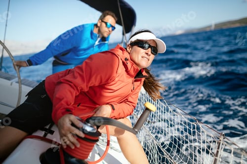 Preview: Attractive strong woman sailing with her boat