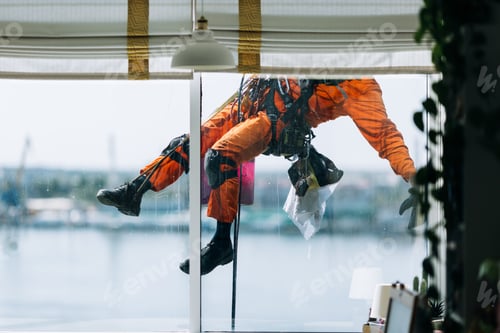 Preview: Industrial climbes is washing glass on the facade of a skyscraper, inside view