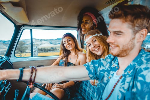 Preview: Happy friends driving a vintage minivan