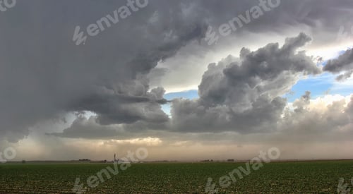 Preview: Storm clouds gather over a vast field.