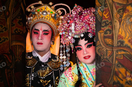 Preview: Portrait of male and female opera performers at the entrance to a sacred shrine or temple,