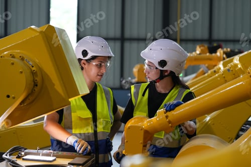 Preview: Robotics engineer working on maintenance of robotic arm in factory warehouse. Business technology.