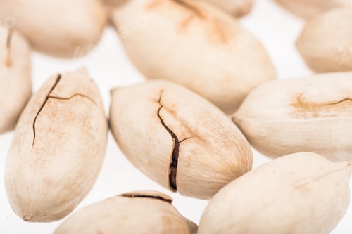 Preview: Close up View of Whole Pistachios in Shell Scattered Isolated on White