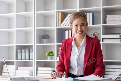 Preview: Attractive and inspired asian businesswoman sits at her desk, looking out the window, and