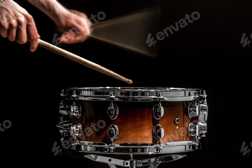 Preview: man plays musical percussion instrument with sticks a musical concept with the working drum