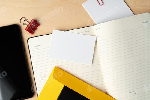 Preview: Mock up of blank business card and black smartphone screen on table