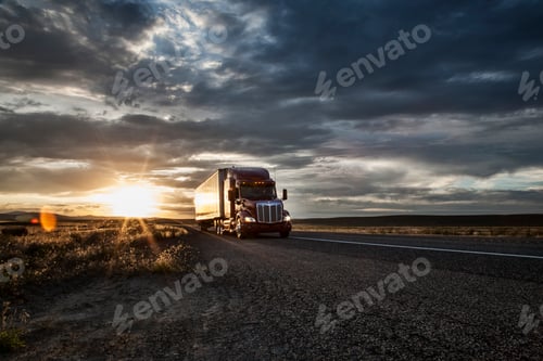 Preview: 3/4 front view of a commercial truck on the road at sunset in eastern Washington, USA