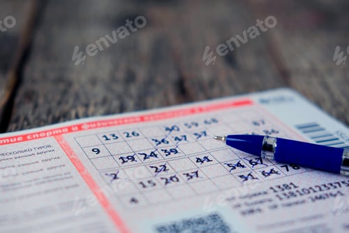 Preview: Filled lottery ticket with a pen on a wooden background.