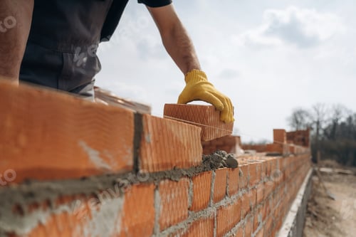 Preview: Making the wall. Close up view of construction man that is working with bricks