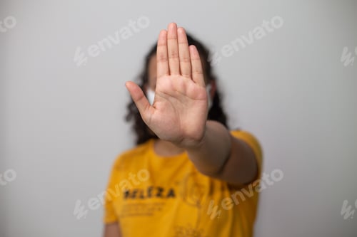 Preview: Person holding their hand in front of their face gesturing stop