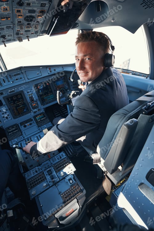 Preview: Cheerful second pilot accelarating plane and staring at camera