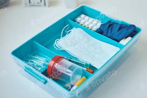 Preview: First aid kit close up. Home medicine box with a medical items. Healthcare and medicine concept