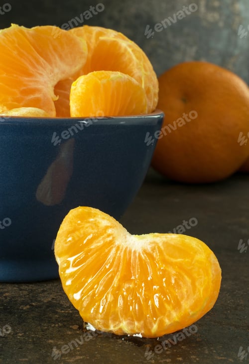 Preview: A blue bowl of orange tangerine segments