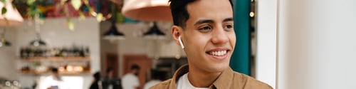 Preview: Smiling young hispanic man in earphones on a video call