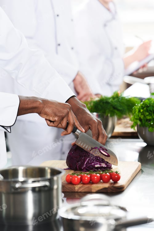 Preview: Close-up view of african american chef cutting cabbage
