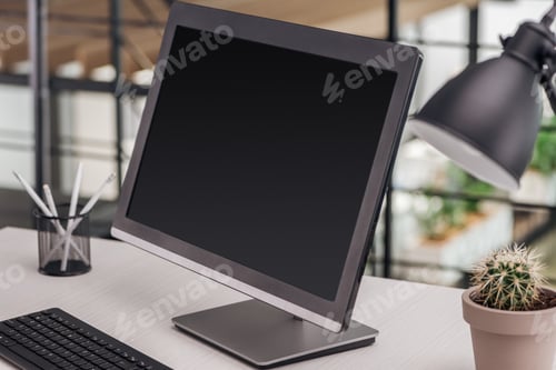 Preview: selective focus of computer with blank screen at workplace in office