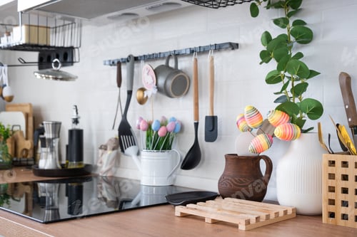 Preview: Interior of kitchen and details of decor of utensils with Easter decoration of colorful eggs in a lo