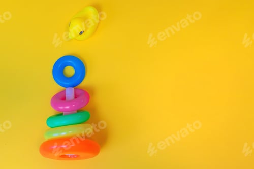 Preview: Accessories for newborns on a yellow background. Selective focus.