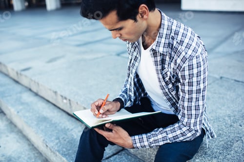 Preview: Intelligent male student with education copybook writing knowledge information