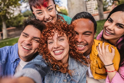 Preview: Happy multi ethnic friends taking selfie in a park, smiling and having fun together