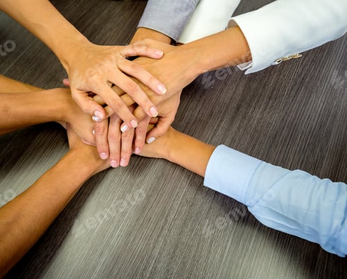 Preview: Business Team In A Meeting With Their Hands Together