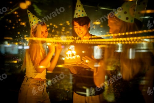 Preview: Happy birthday party with friends in low light.