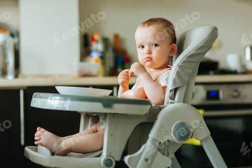 Preview: domestic scene with a baby little boy eating spaghetti.