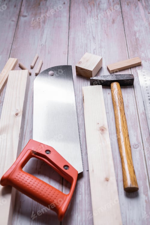 Preview: Pieces of wood and tools for construction and repair on a wooden table