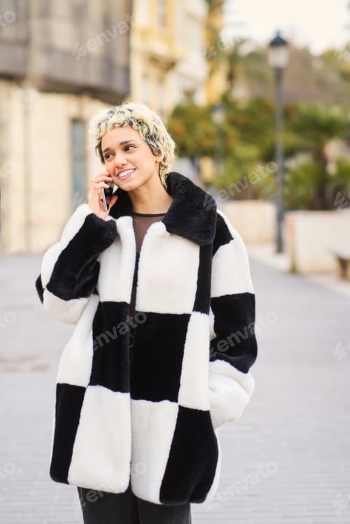Preview: Woman making phone call on city street