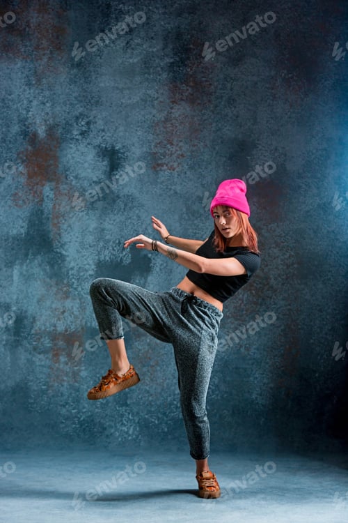 Preview: Young girl break dancing on wall background.
