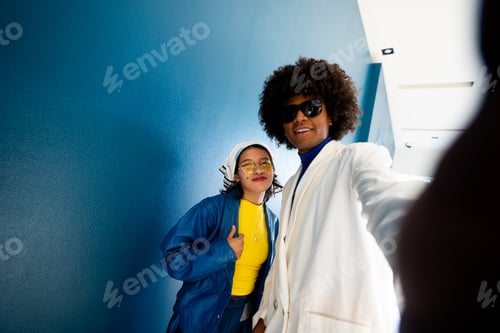 Preview: Afro mexican man taking an horizontal selfie with his young woman friend