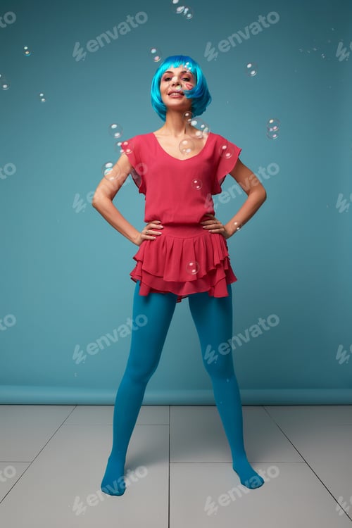 Preview: Beautiful young woman with blue wig and bright make-up in soap bubbles. Fashion model girl with