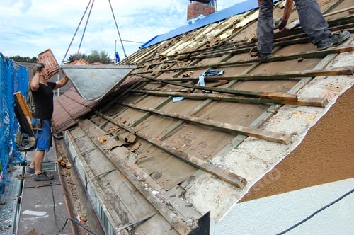Preview: Builder removing old roof tiles from an open roof