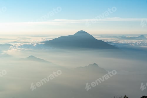 Preview: Shot of a misty mountain under a clear sky