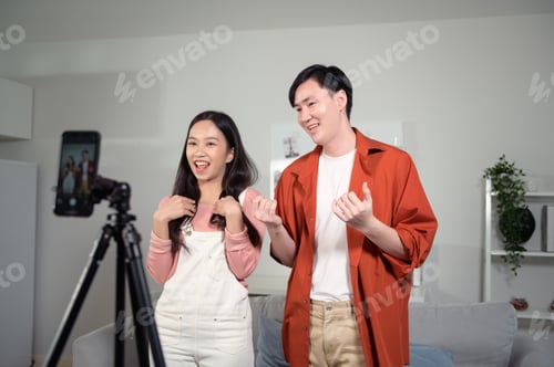 Preview: Young couple tiktokers are making video dancing via smartphone